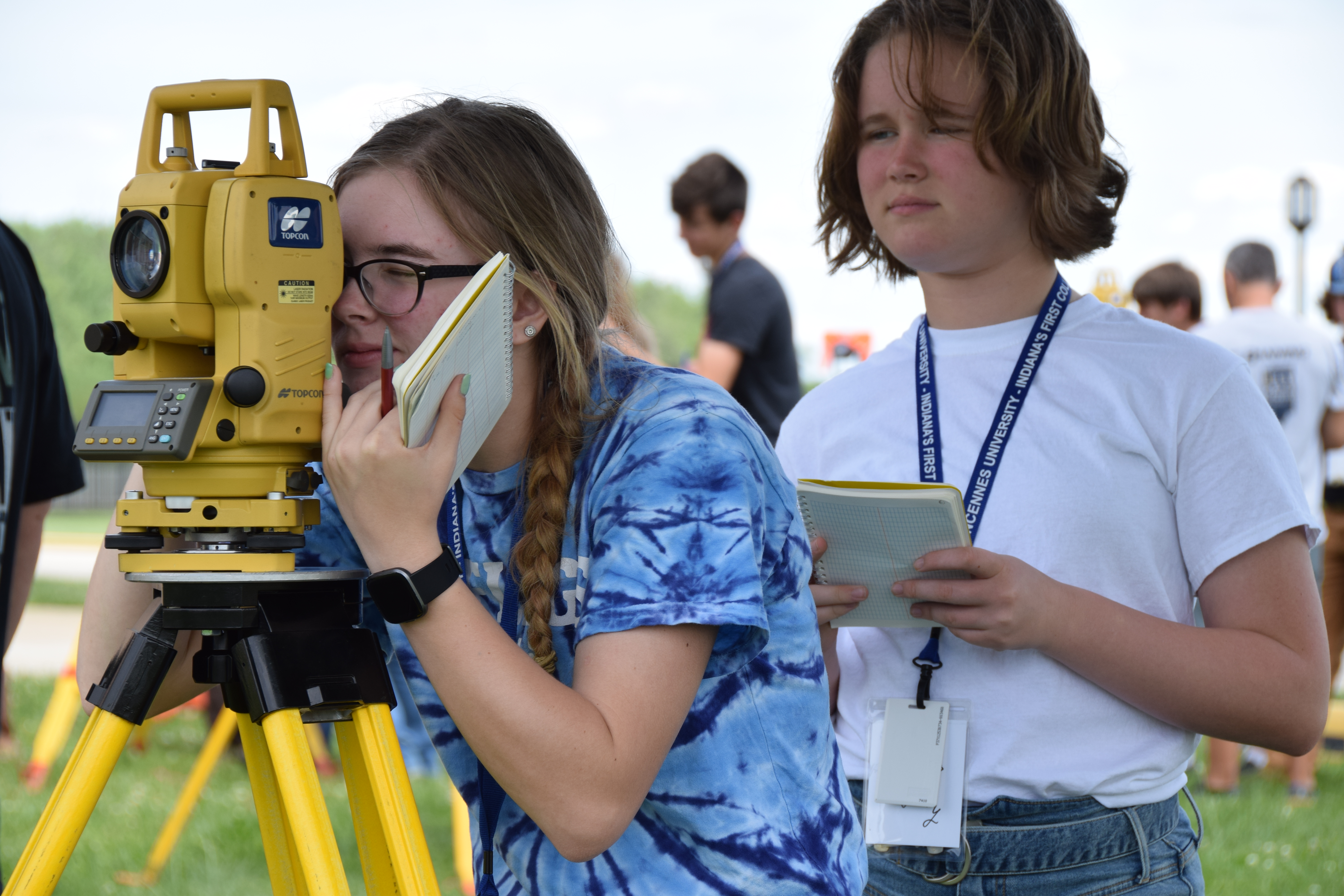 Two female campers using surveying equipment during Surveying Summer Camp