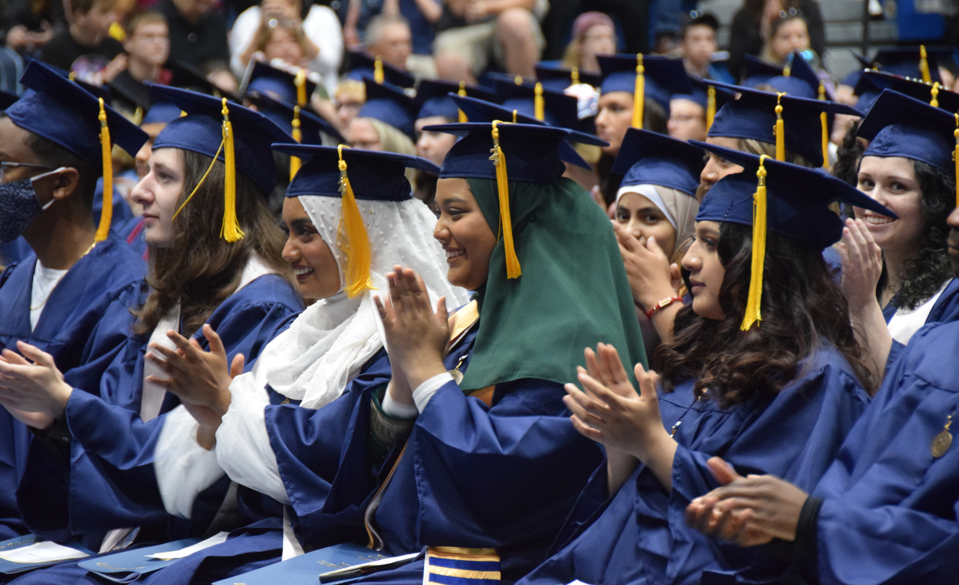 VU Graduates wearing caps and gowns applaud during 2022 Spring Commencement ceremony